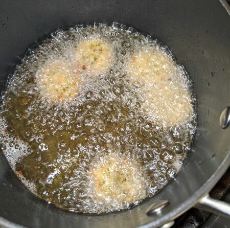 Falafel frying in Pan of Hot Oil