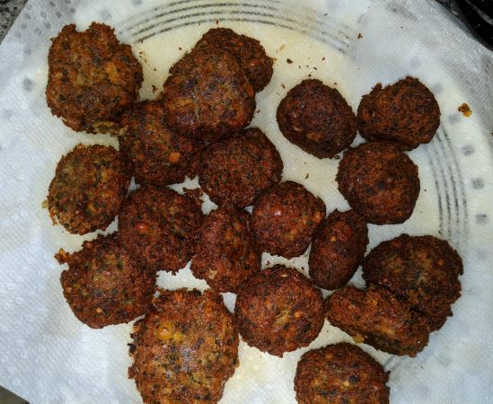 Falafel on a paper towel lined plate after frying