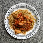 Chicken Cacciatore over Pasta on plate