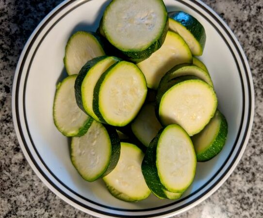 Bowl full of sliced zucchini.