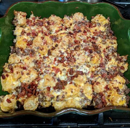 Bacon Cheeseburger Tater Tot Casserole in Green Ceramic Dish