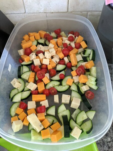 Cucumbers, Tomatoes and Cubed Cheeses in container