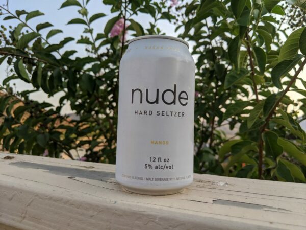 Mango Nude Hard Seltzer Can on Fence