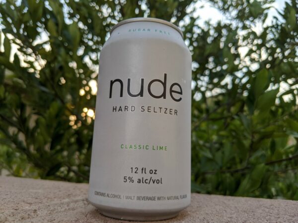 Classic Lime Nude Hard Seltzer Can on fence