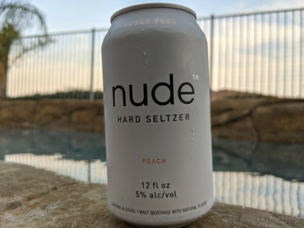 Peach Nude Hard Seltzer can poolside