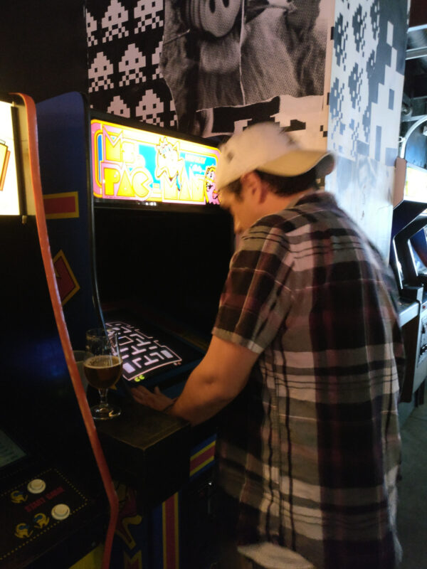 Man playing Ms. Pac-Man at Up Down Kansas City