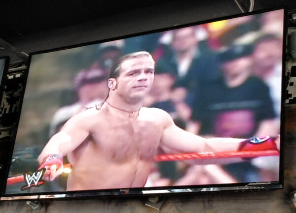 Wrestling match on television at Up Down Kansas City