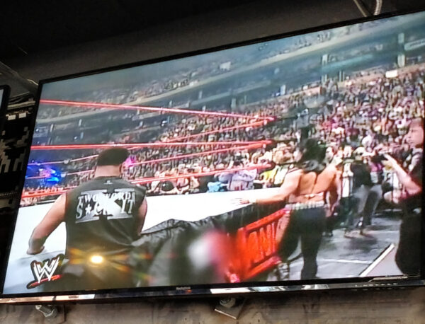 tv screen with wrestling match at at Up Down Kansas City