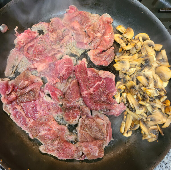 Steak and Mushrooms cooking in pan