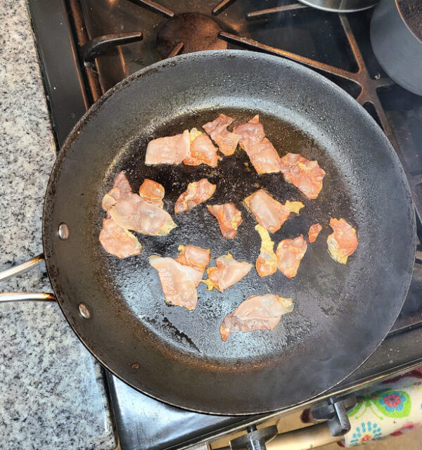 Prosciutto frying in pan