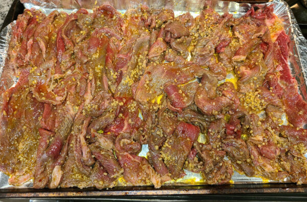 Marinated steak on tray