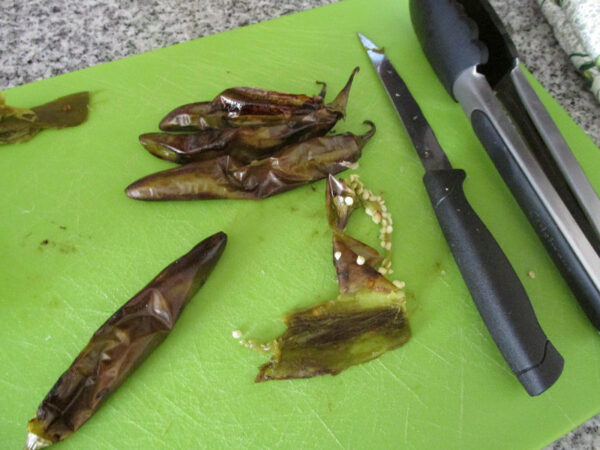 hatch chiles- removing skin after roasting for chile verde