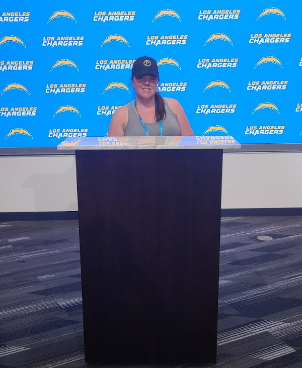 Los Angeles Chargers Press Room Lora standing behind the podium.