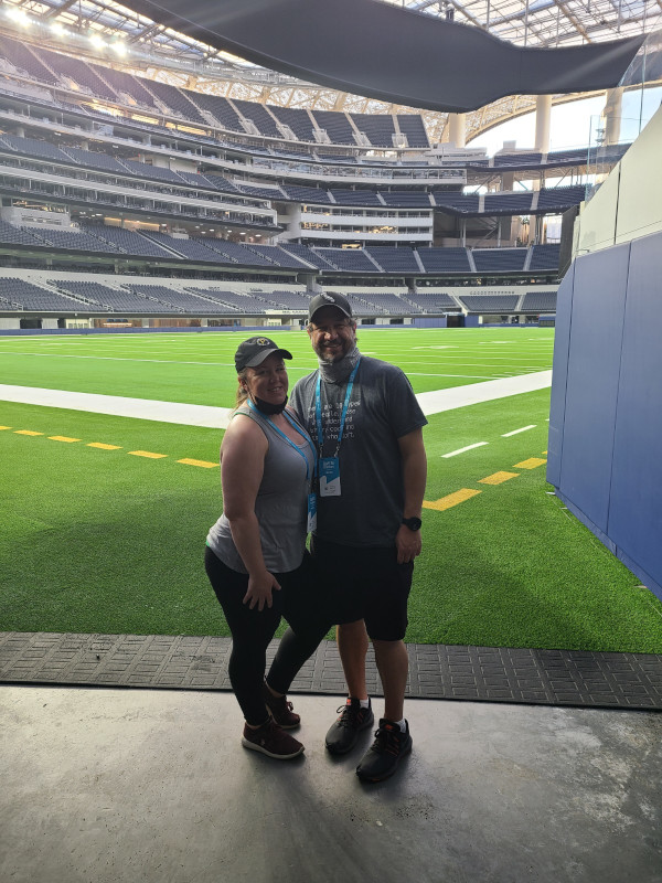 Couple standing near the field at SoFi Stadium