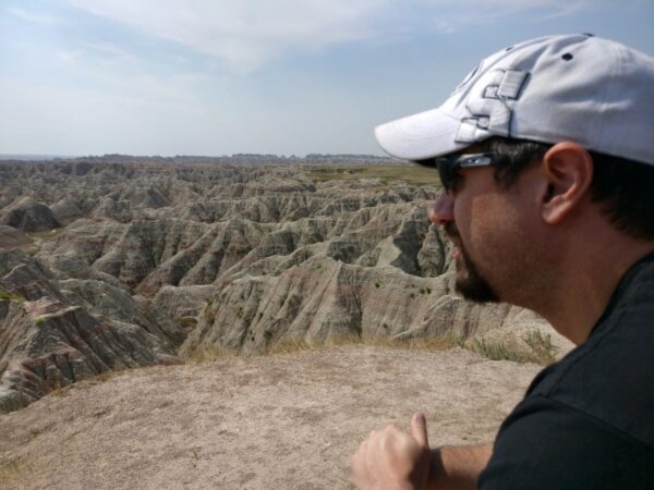 Man standing gazing upon Badlands National Park