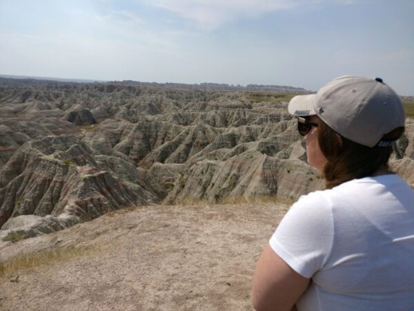 Woman standing and gazing upon Badlands National Park