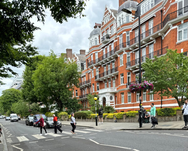 Woman crossing the intersection at Abbey Road in London in St. John's Wood
