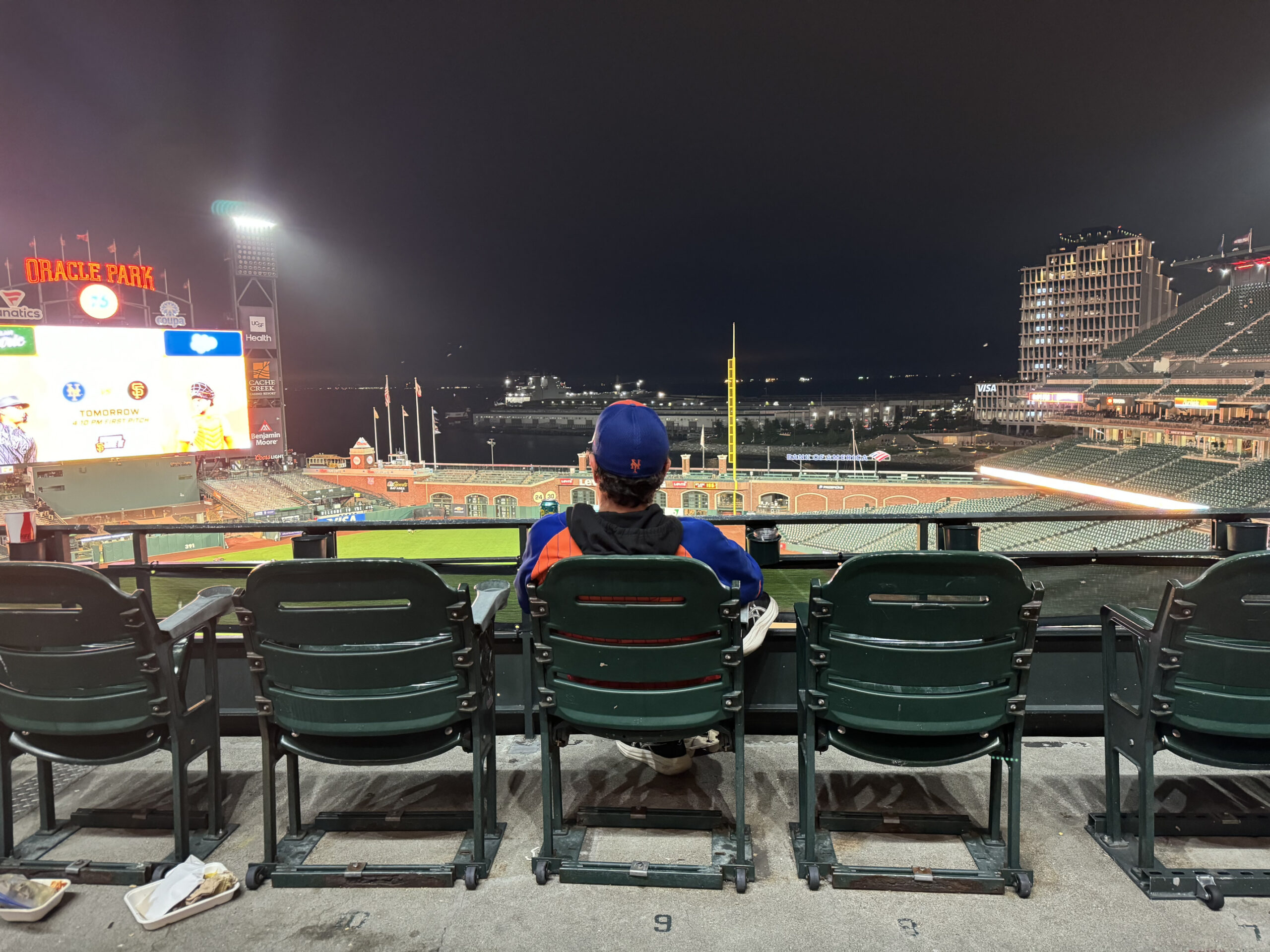 Man looking onto field at Oracle Park, home of the San Francisco Giants
