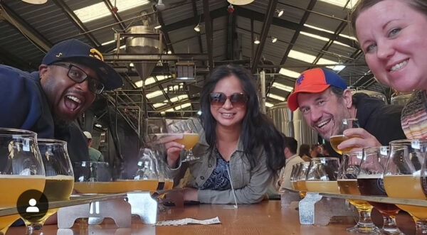 Friends enjoying beers at Bottleneck Brewing in San Francisco, California