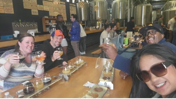 Friends enjoying beers at Bottleneck Brewing in San Francisco, California